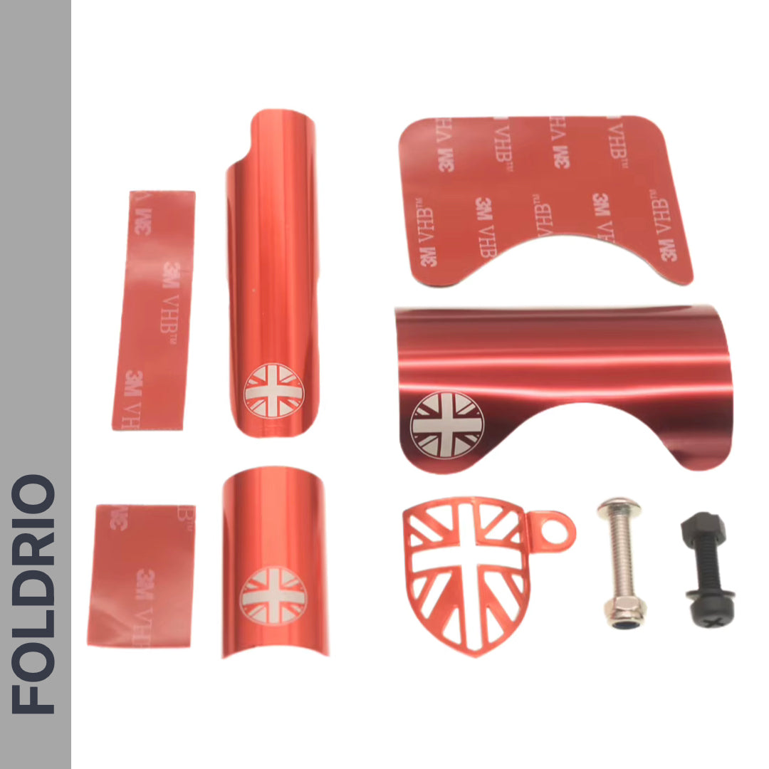 FOLDRIO Brompton Frame Protector Set with British Flag: red metal protectors, adhesive strips (some with Union Jack), and two bolts displayed on a white background. "FOLDRIO" appears vertically on the left side.