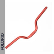 The Brompton M Handlebar – Anodised Aluminium, shown in red and curved for an upright ride, is displayed diagonally on white. A gray left strip features "FOLDRIO" in bold black, emphasizing style and fit for Brompton bikes. Available in 5 colours.