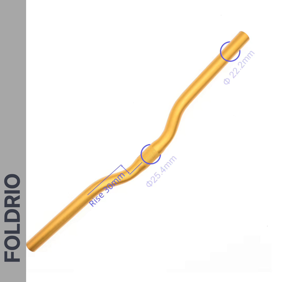 The Brompton M Handlebar – Anodised Aluminium (gold), features a 30mm rise, 25.4mm and 22.2mm diameters for an upright ride; "FOLDRIO" appears vertically on its grey side panel.