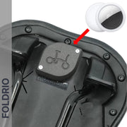 Close-up of the Brompton AirTag Saddle Mount, a black bike saddle underside with a hidden tracker holder. An inset shows a white AirTag with red arrow pointing to the holder. FOLDRIO branding highlights this anti-theft bike tracker.