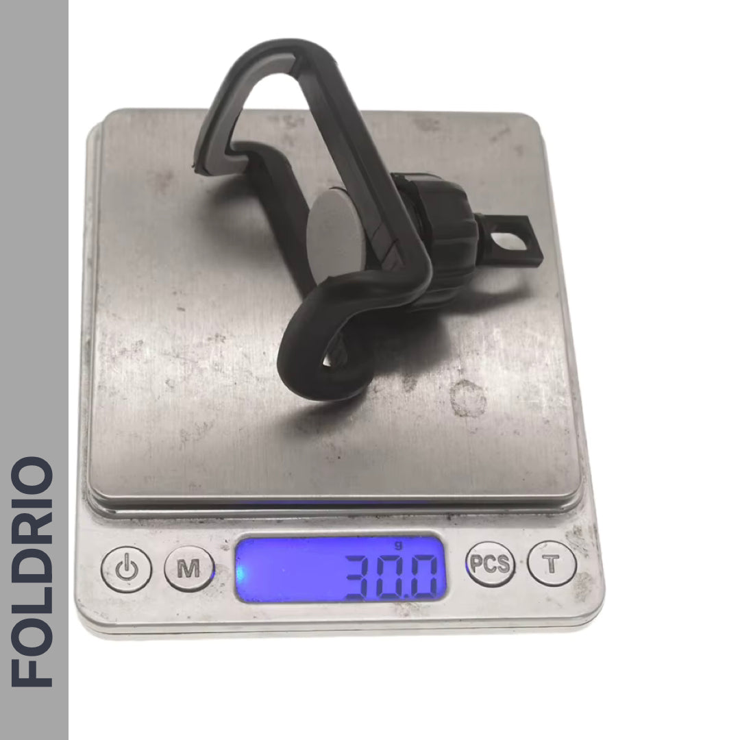 A FOLDRIO Brompton Phone Mount – Lightweight, No Case Needed, sits on a digital scale reading 30 grams. The brand name FOLDRIO appears vertically along the left side of the image.