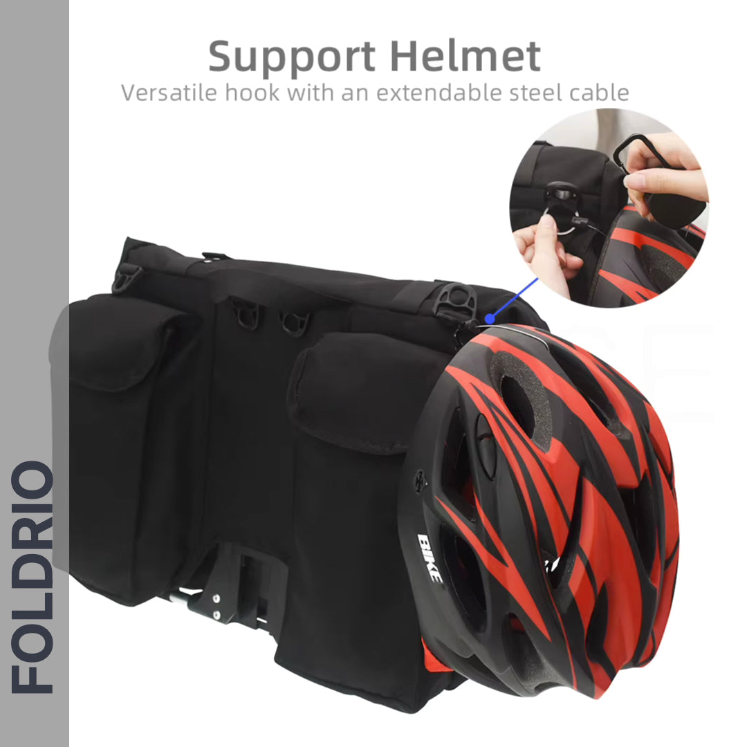 A FOLDRIO Brompton Roll-Top Front Bag – 27.5L holds a bike helmet with red and black stripes, hanging from a versatile hook with an extendable steel cable. Inset shows the hook securing the helmet. Text: “Support Helmet” and “FOLDRIO.”.