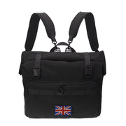The FOLDRIO Brompton Roll-Top Front Bag – 27.5L is a black laptop and commuter bag with padded shoulder straps, a front pocket, and a United Kingdom flag patch on the lower front.