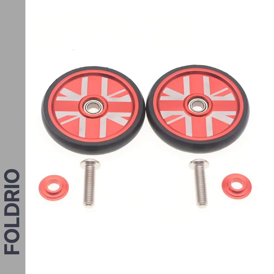 The FOLDRIO Brompton Easy Wheels Union Jack Edition includes two small red aluminum alloy wheels with central bearings, two red washers, and titanium bolts. "FOLDRIO" appears vertically on a grey strip at the left.