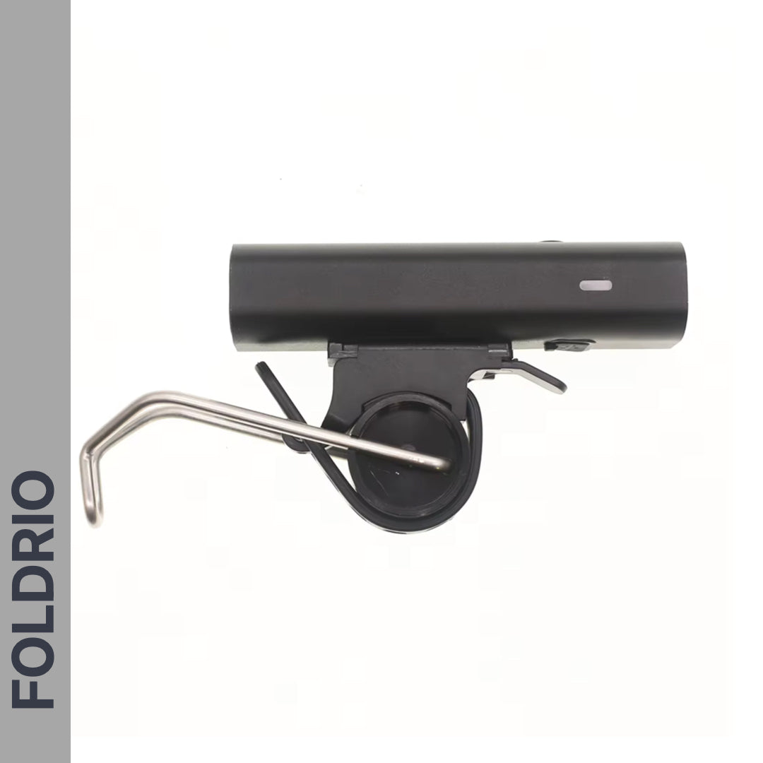 A black and silver Brompton Front Fork Light – 400 Lumen, USB-C Rechargeable by FOLDRIO is shown on a white background. "FOLDRIO" appears vertically on a grey bar along the left side.