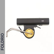 A black and gold Brompton Front Fork Light (400 Lumen, USB-C Rechargeable) by FOLDRIO is shown against a white background. The FOLDRIO logo appears vertically on a grey side panel for secure bike light attachment.