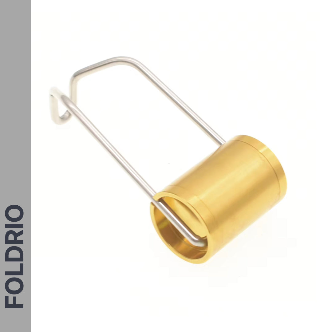 A compact golden cylindrical Brompton Front Fork Light by FOLDRIO with a silver wire handle rests on a white background. It features an adjustable beam up to 400 lumens, USB-C rechargeability, and "FOLDRIO" vertically on a grey side strip.