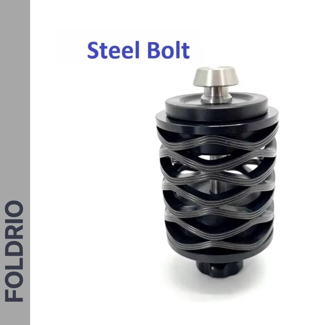 A close-up of a black steel Brompton Rear Shock Absorber with a unique spiral design stands upright on a white background. "Brompton Rear Shock Absorber" appears above, and "FOLDRIO" is written vertically on the left, highlighting its premium quality.