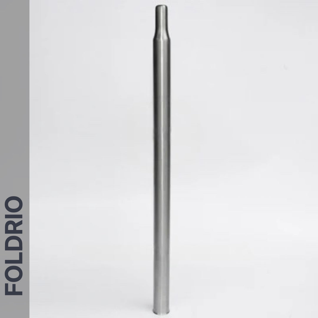 A straight, metallic Brompton Titanium Seatpost – Multicolour Edition stands upright on a plain white background. The word FOLDRIO is printed vertically along a gray bar on the left side.