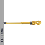 A gold-colored FOLDRIO Brompton Kickstand – Adjustable Aluminium (A and C Line) with a rubber tip and rear axle mount is displayed horizontally on a white background, with “FOLDRIO” shown vertically on a gray sidebar to the left. Ideal for upgrades.