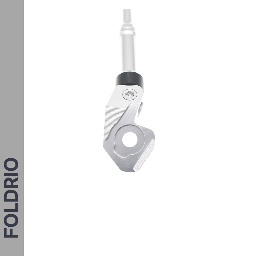 Close-up of the FOLDRIO Brompton Kickstand – Adjustable Aluminium for A and C Line, showing the rear axle mount against a white background with "FOLDRIO" in bold on a gray strip to the left.