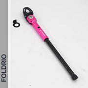 A pink and black FOLDRIO Brompton Kickstand – Carbon Fibre, P and T Line with an adjustable arm and mounting hardware is shown on a white background. The word FOLDRIO appears vertically on the left side.