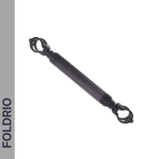 The FOLDRIO Brompton M Handlebar Cross Brace—Adjustable and available in 6 colours—appears on a white background with a left gray strip displaying "FOLDRIO" in bold capitals. It’s a black carbon fiber accessory with clamps at both ends.