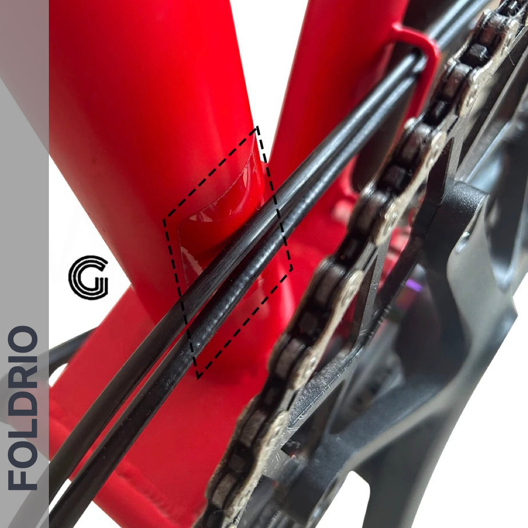 Brompton Brompton red frame rear triangle with black cables, chain, and dashed box highlighting FOLDRIO protection area | Foldrio. Foldrio